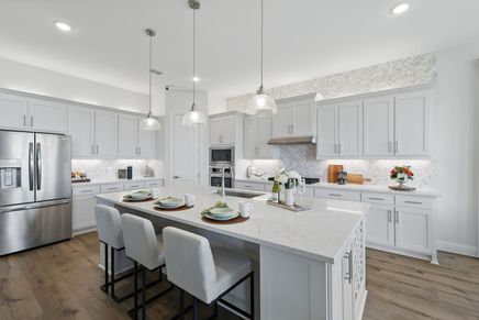 Luxurious marble island and herringbone backsplash define this Rio Vista kitchen's elegance.
