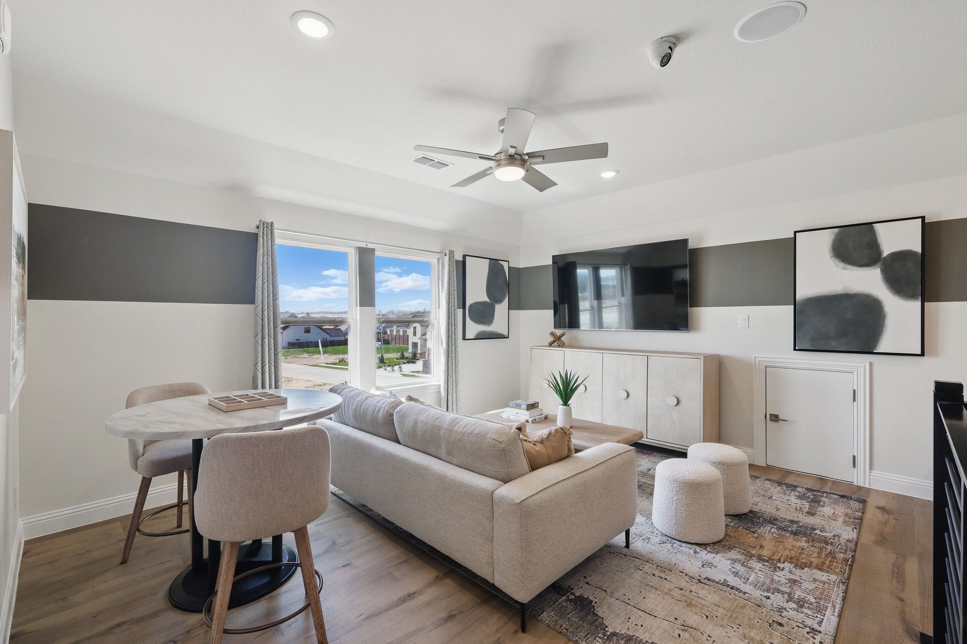 Elegant living area with marble accents and abstract art. Located in Rio Vista at Kelly Ranch.