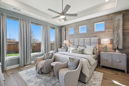 Experience luxury with wood accent walls, plush bedding, and expansive windows at Rio Vista Kelly Ranch.