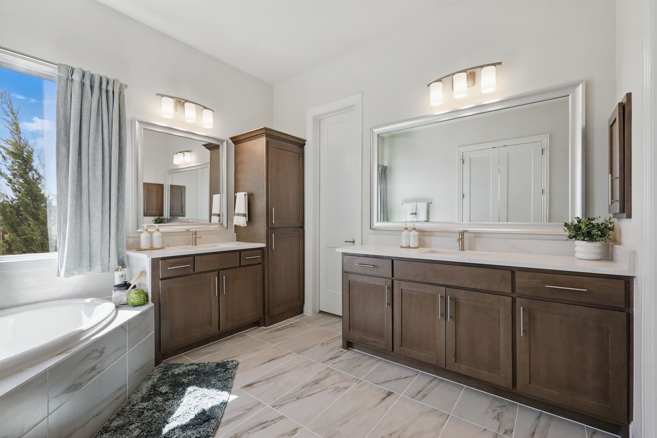 Experience bespoke design with dual sinks, sophisticated cabinetry, and exquisite marble tile at Rio Vista, Kelly Ranch.