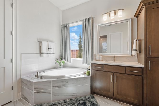 Experience luxury with sleek marble tiles and rich wood cabinetry in Rio Vista at Kelly Ranch.