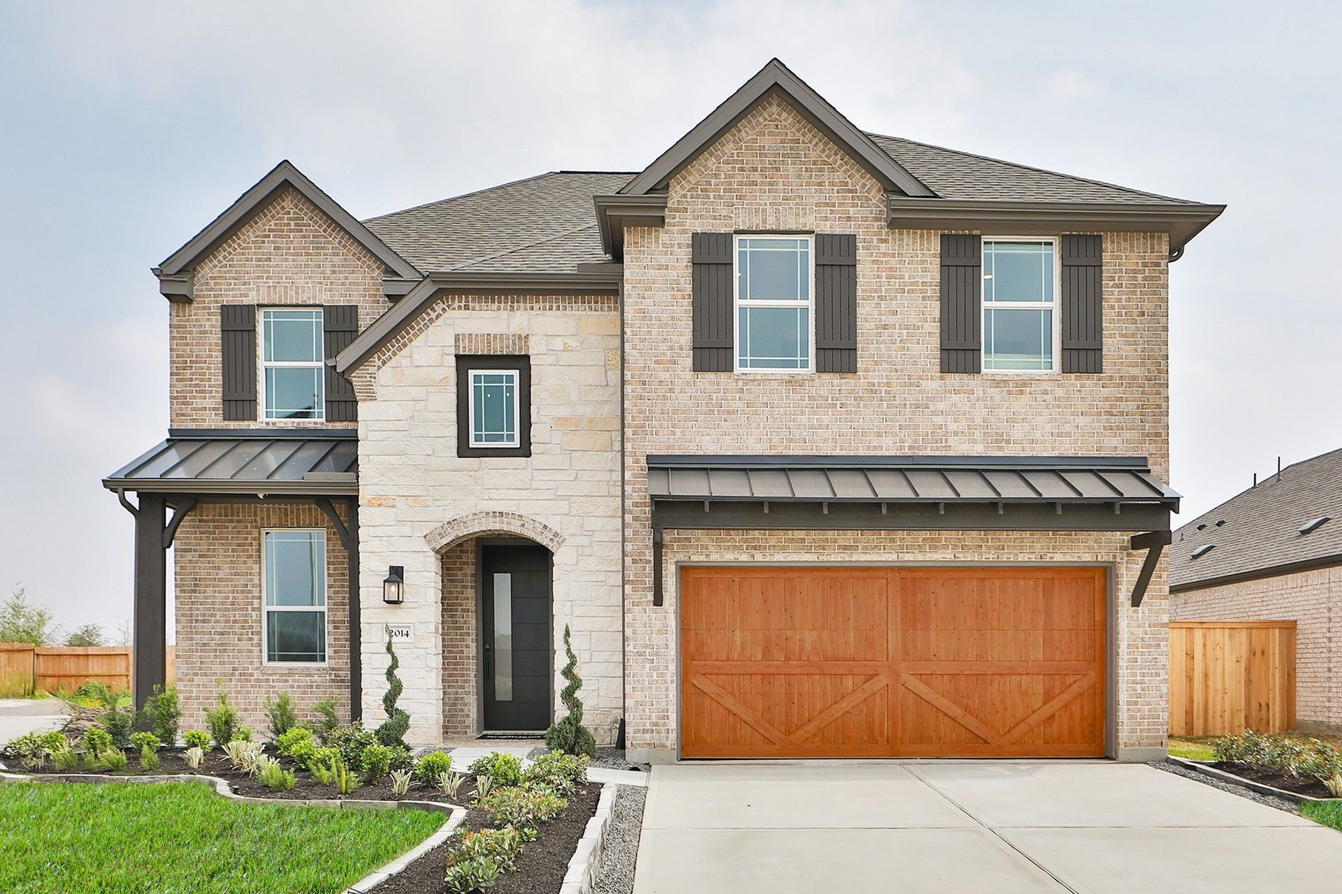 Elegant brick facade with wood garage, refined trim. Nestled in the desirable Park at Eldridge.