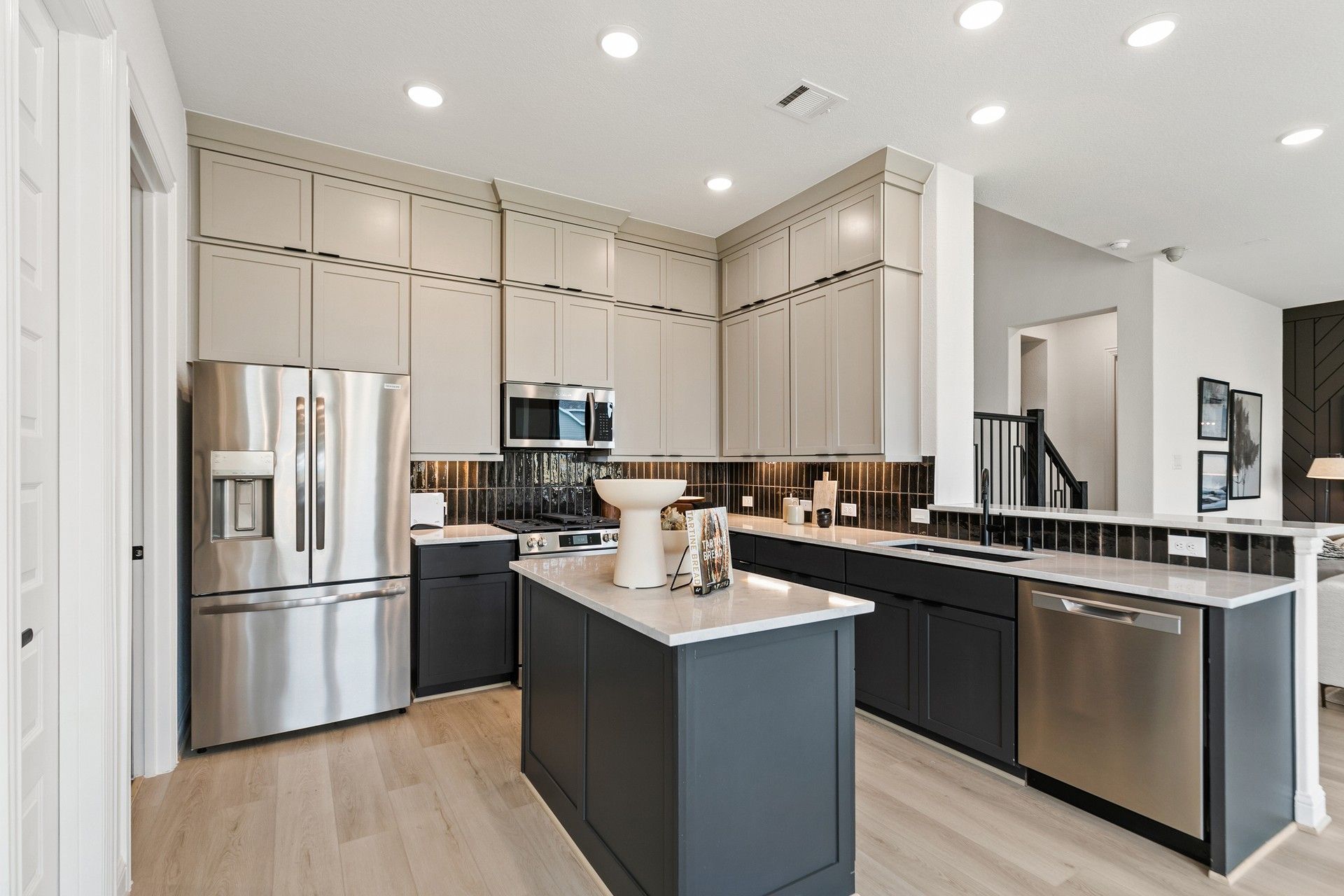 Elegant kitchen with high-end cabinetry, luxurious countertops, and premium appliances in Park at Eldridge, Houston.