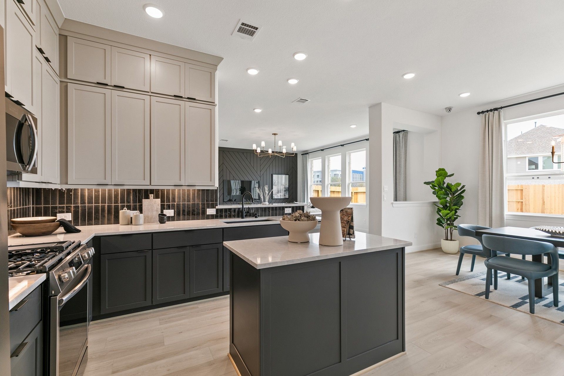Sleek quartz countertops and refined cabinetry define this luxurious kitchen in Park at Eldridge.