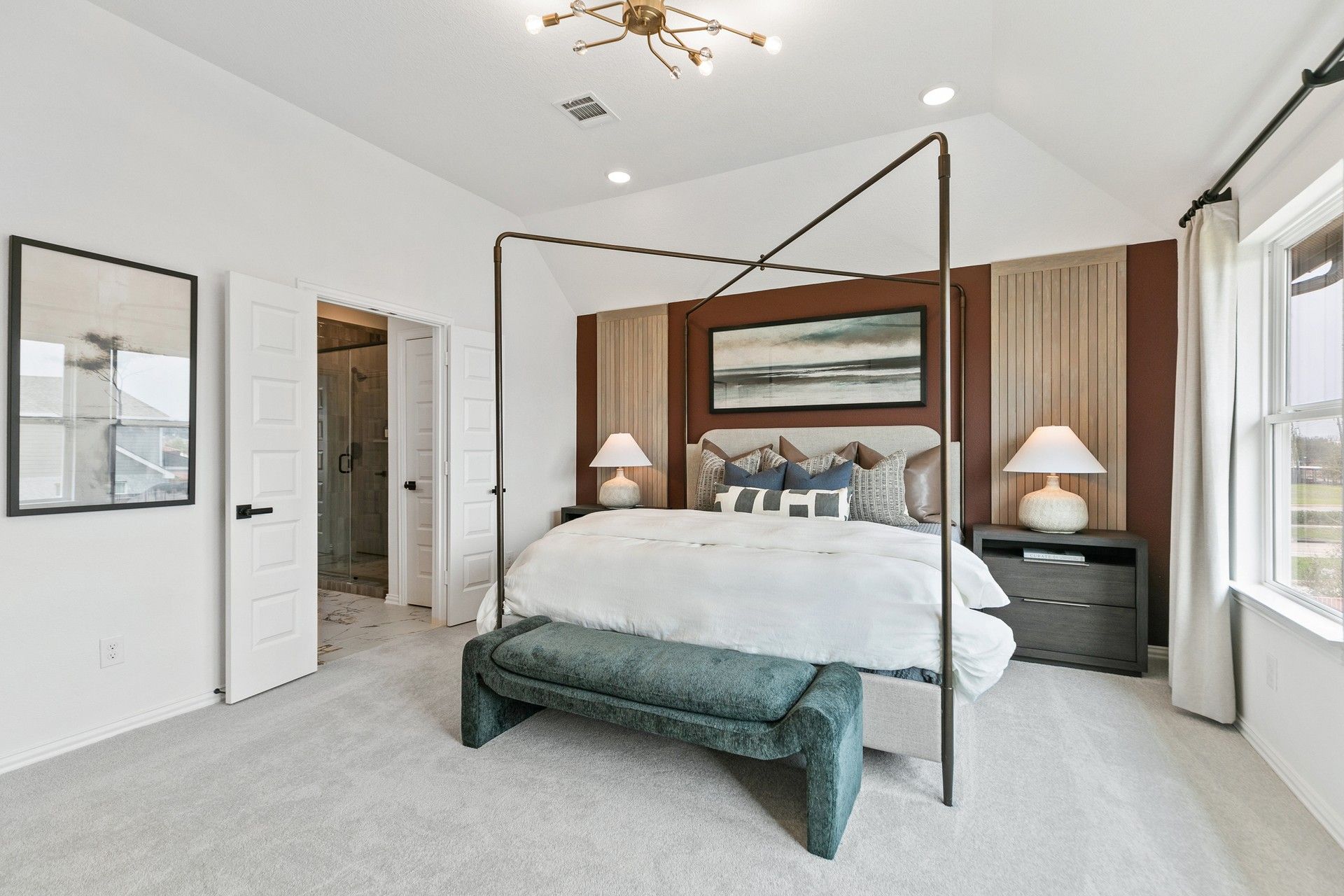 Elegant four-poster bed and modern lighting create a chic ambiance in this Park at Eldridge bedroom.