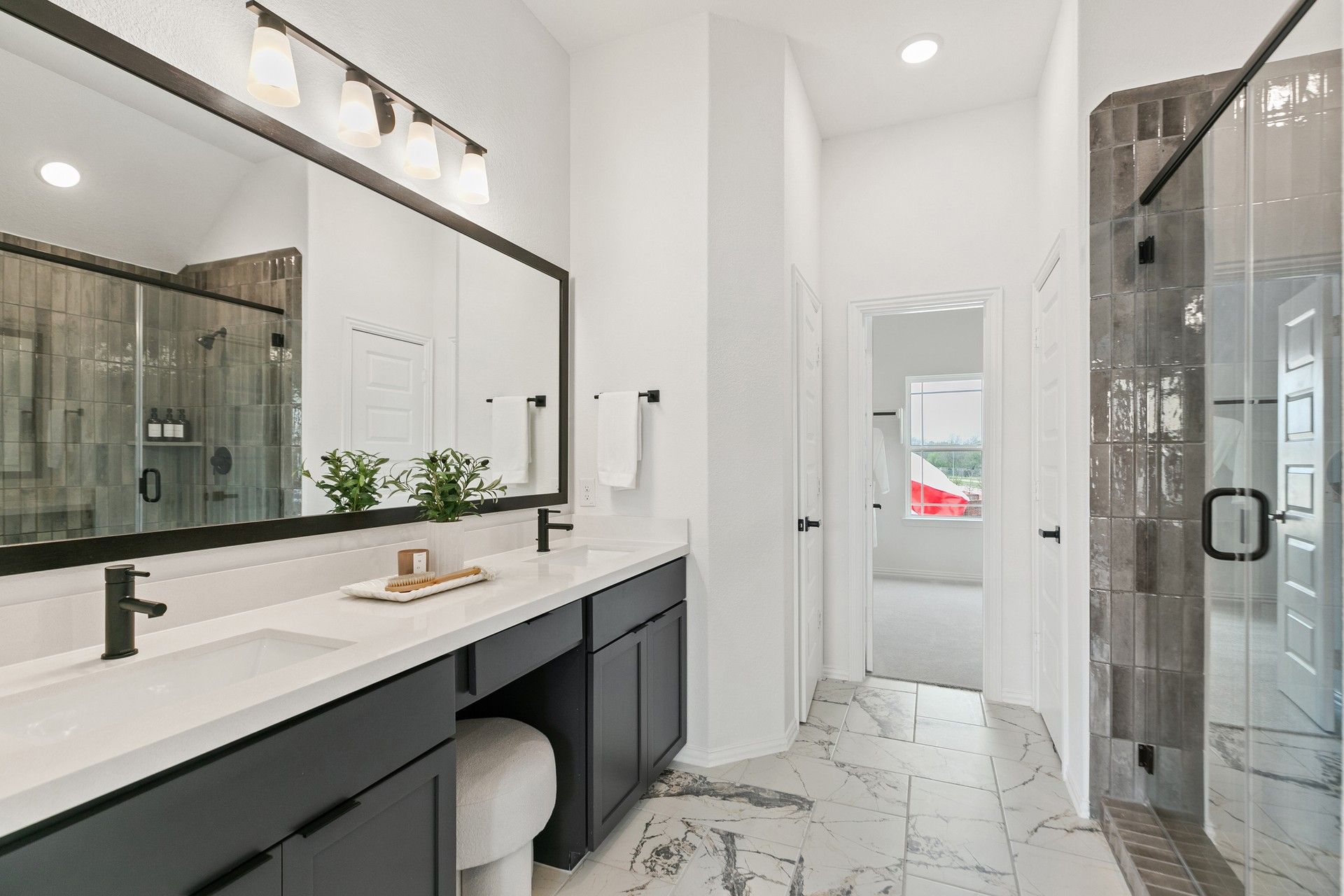 Sleek marble floors and opulent finishes in this Park at Eldridge bath exude luxury and sophistication.