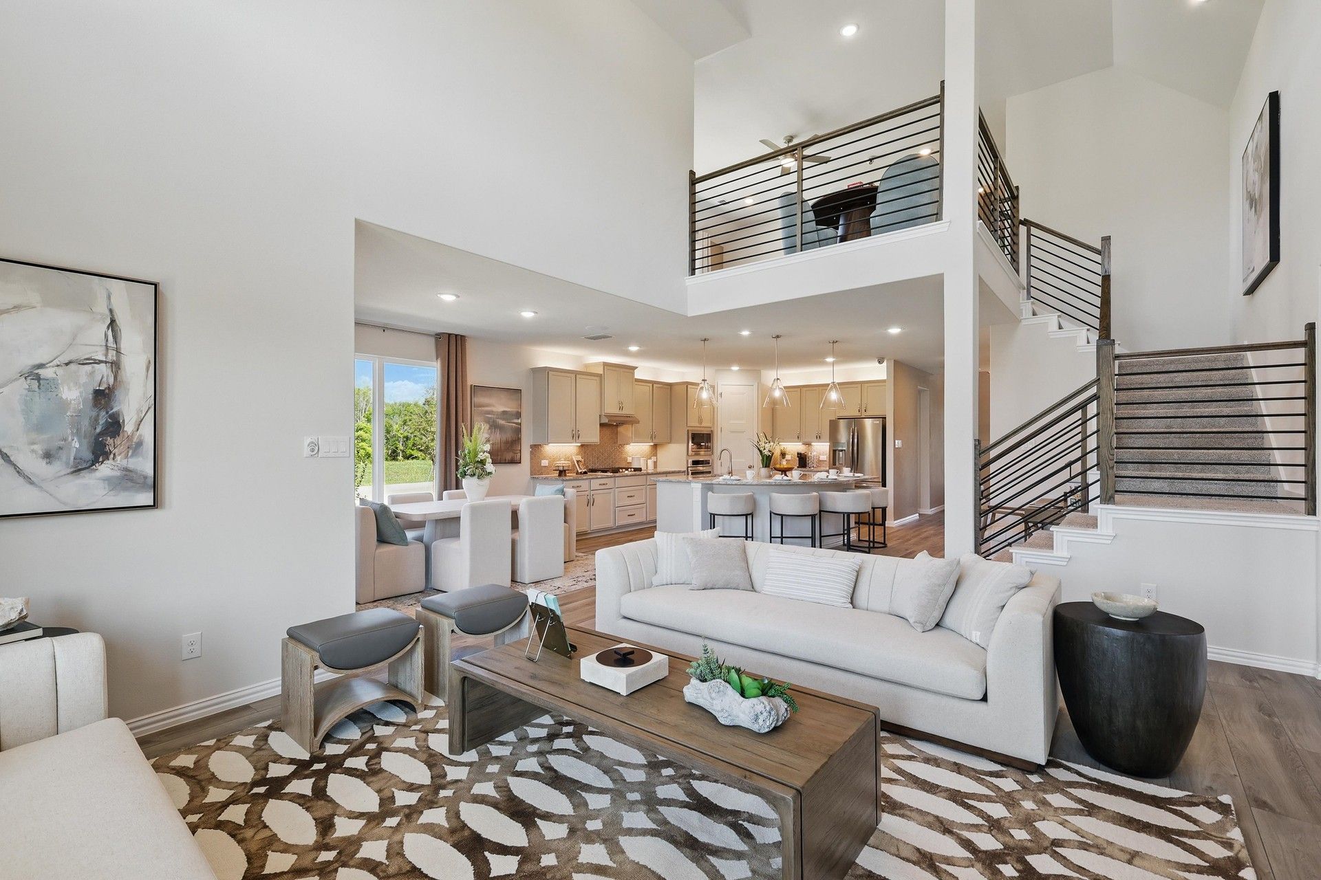Experience modern elegance with a vaulted ceiling, open-plan kitchen, and chic staircase in Green Oaks Preserve.