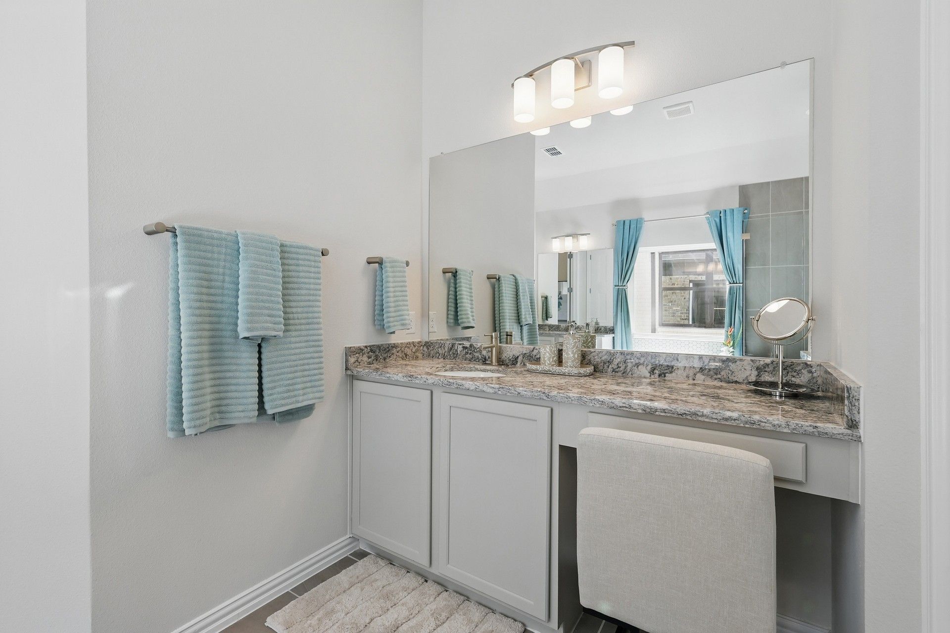 Experience luxury with a marble vanity, sleek light fixtures, and refined fittings in Green Oaks Preserve.