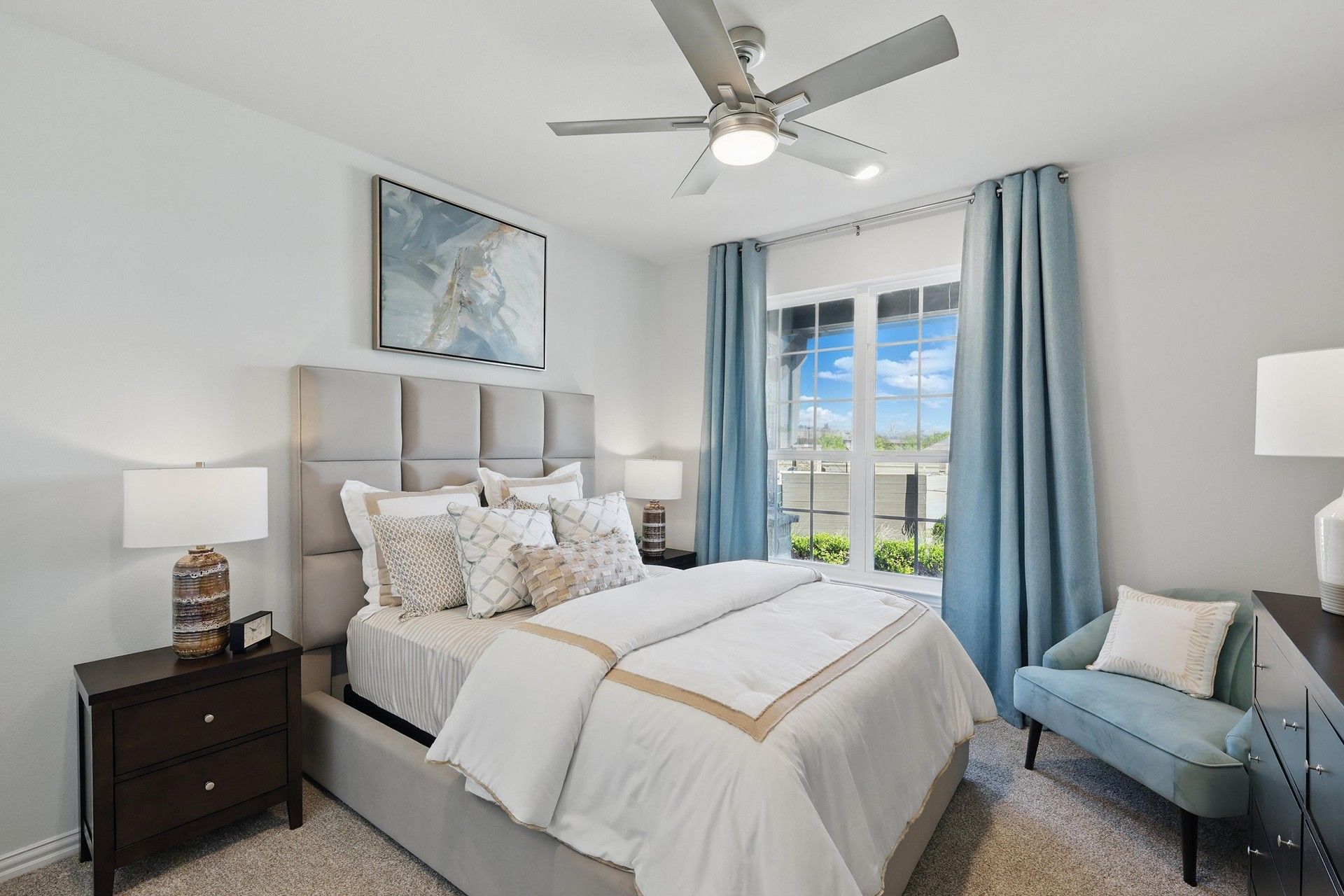 Experience plush comfort with exquisite details like a tufted headboard and serene garden views in Green Oaks Preserve.