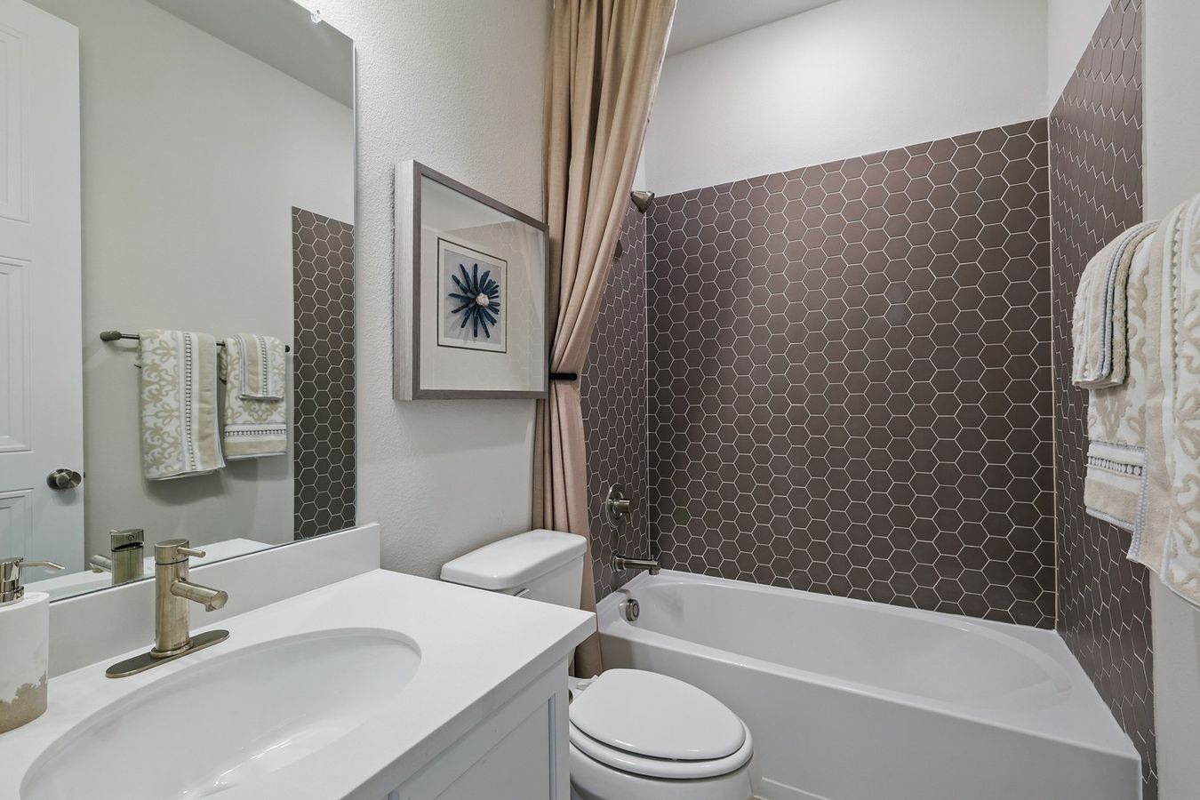 Features refined hexagonal tiling and premium fixtures, showcasing Green Oaks Preserve's luxury.