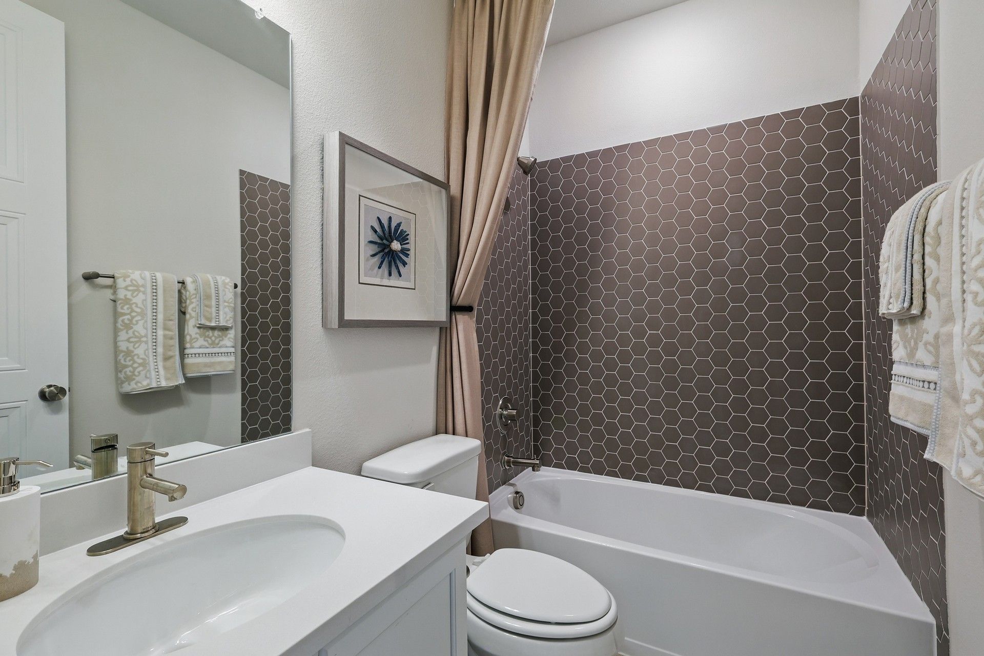 Features refined hexagonal tiling and premium fixtures, showcasing Green Oaks Preserve's luxury.