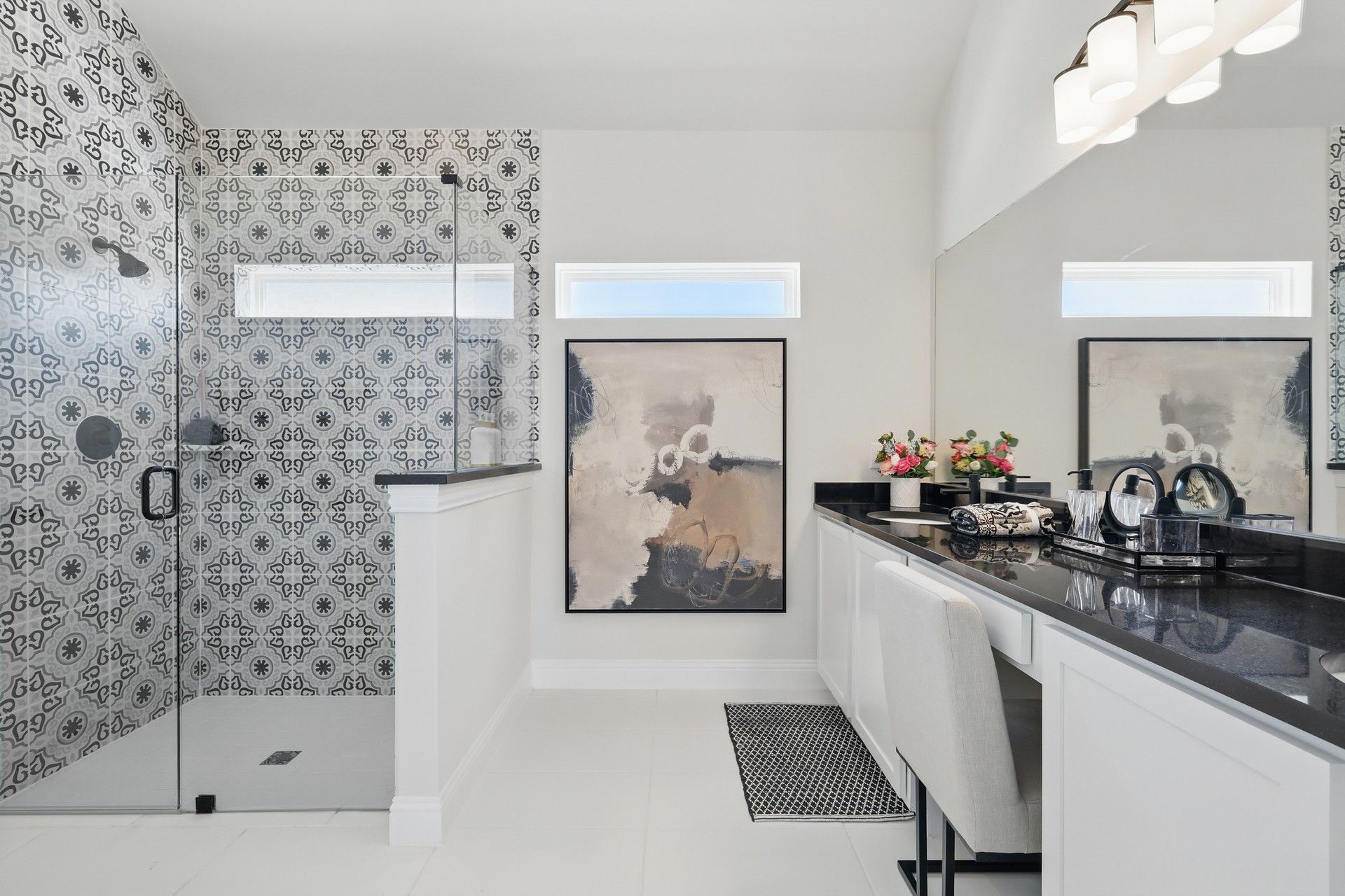 Experience sophistication with patterned tile shower and sleek counters in Green Oaks Preserve's exquisite bathroom.