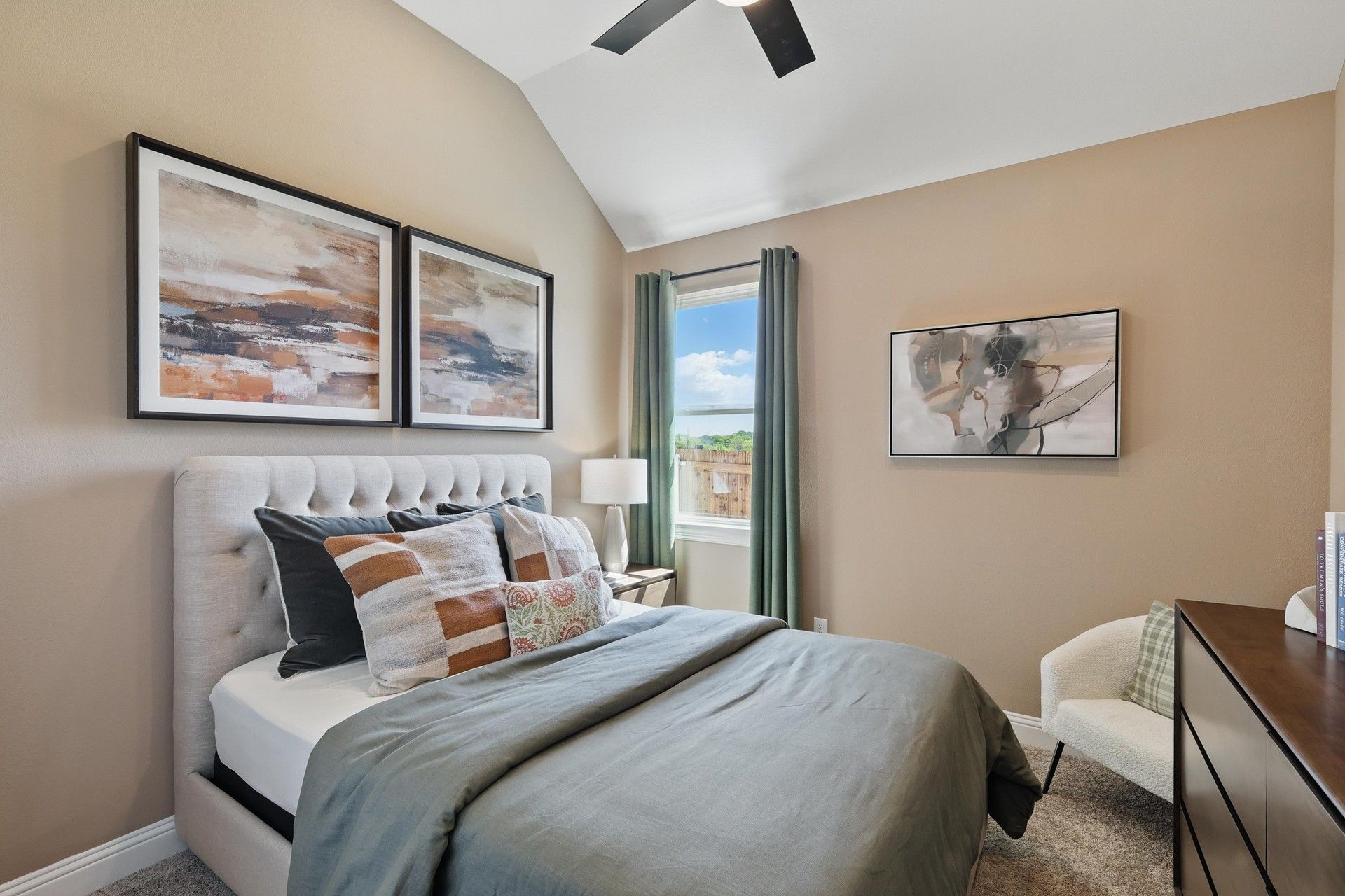 Vaulted ceilings and plush bedding highlight this Green Oaks Preserve bedroom's refined elegance.