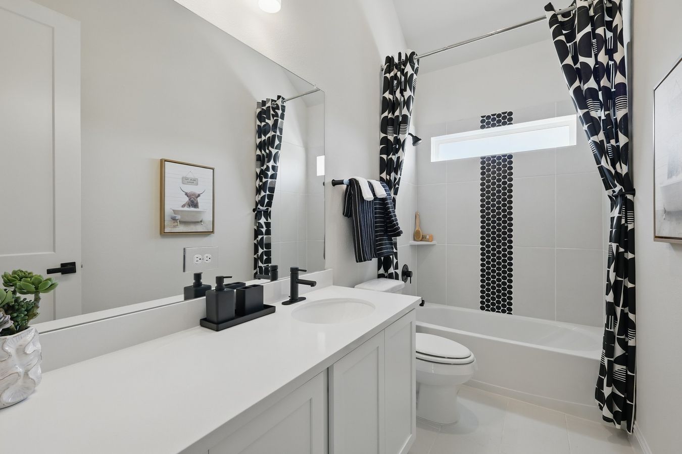 Contemporary design with luxury black hardware, geometric patterns, and sleek lines in Green Oaks Preserve.