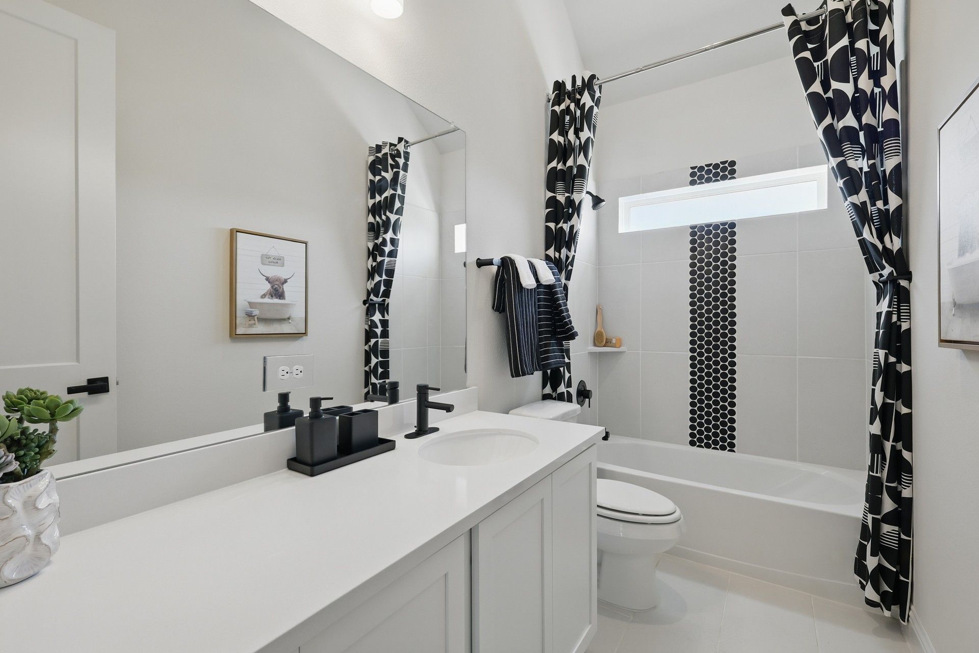 Contemporary design with luxury black hardware, geometric patterns, and sleek lines in Green Oaks Preserve.