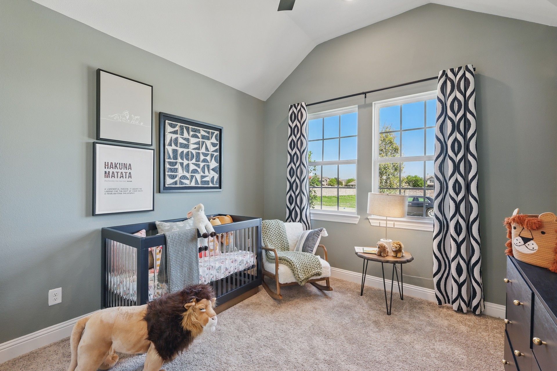 Exquisite nursery with elegant artwork, plush carpet, and expansive windows in Green Oaks Preserve.