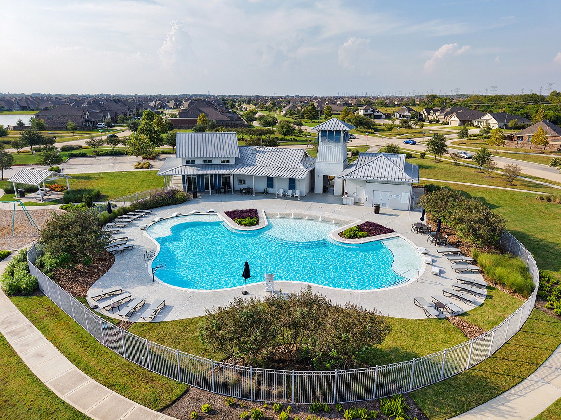 Elegant resort-style pool with sleek clubhouse, offering a luxurious retreat in League City, TX.