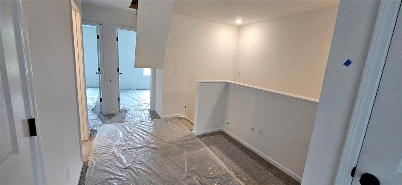 This spacious hallway features neutral tones and l