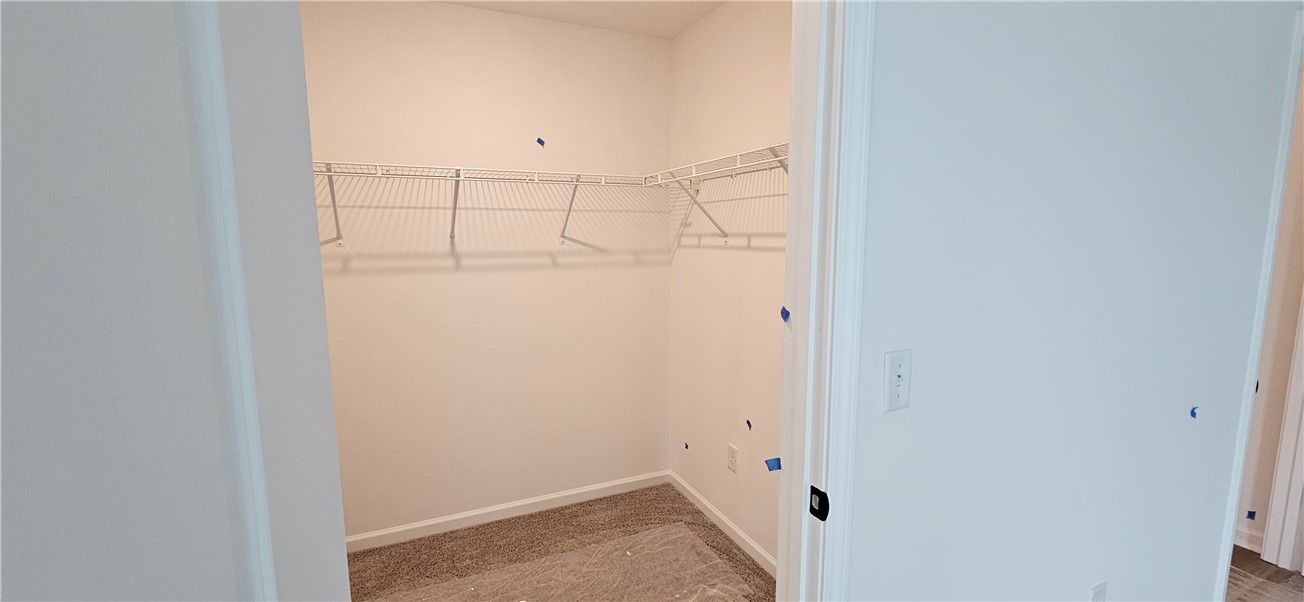 This spacious walk-in closet offers ample storage