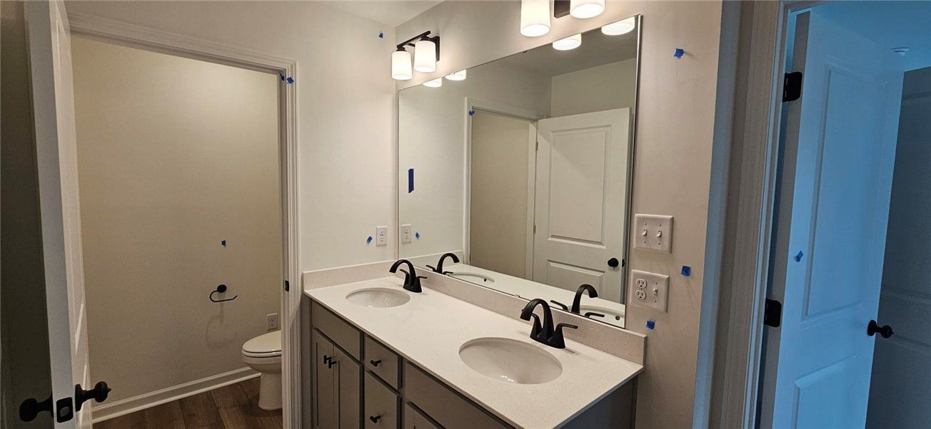 This bathroom features a double vanity with ample