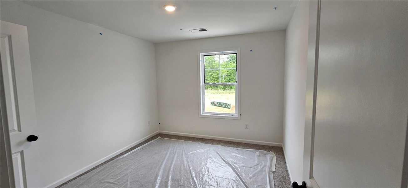 This spacious bedroom offers ample natural light a