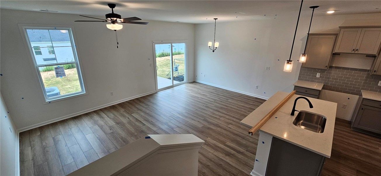 This bright and open layout combines kitchen, livi