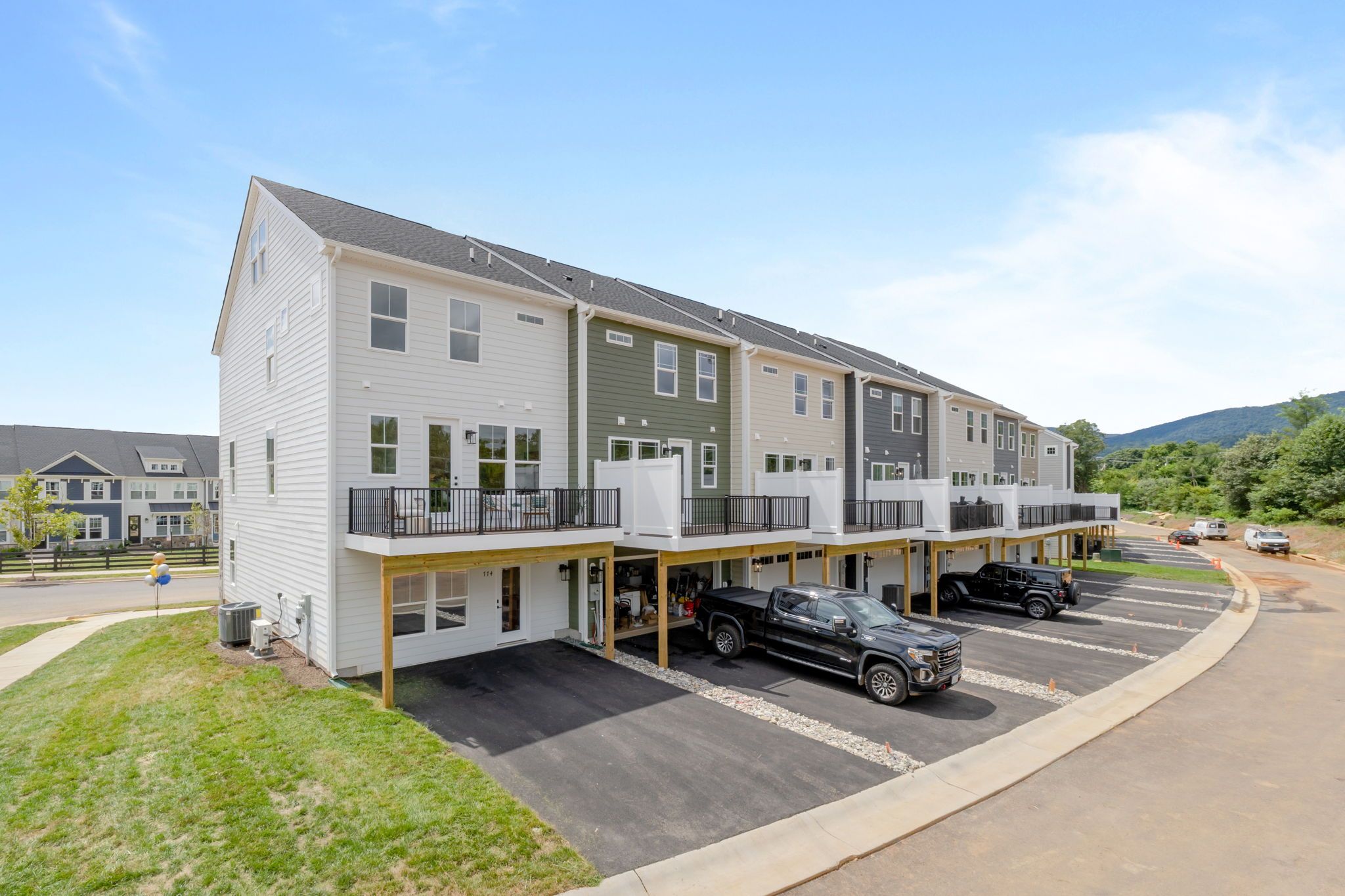 Rear of Home - Two Car Garage is standard; Sales office shown in photo