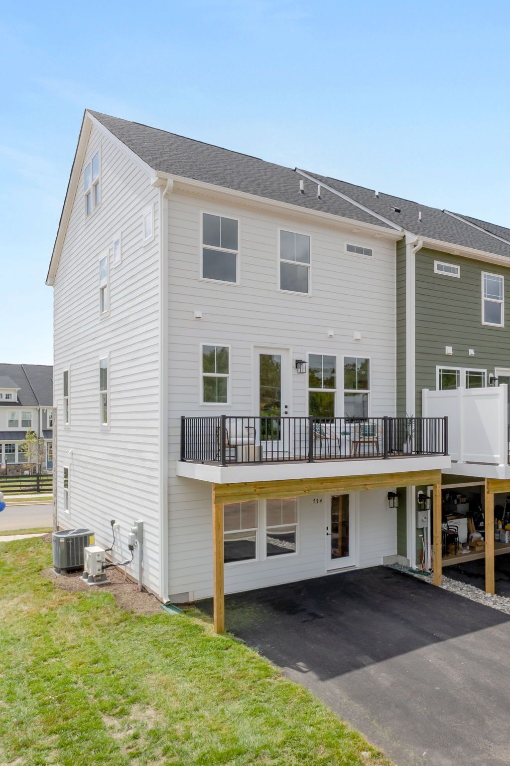 Rear of Home - Two Car Garage is standard; Sales office shown in photo