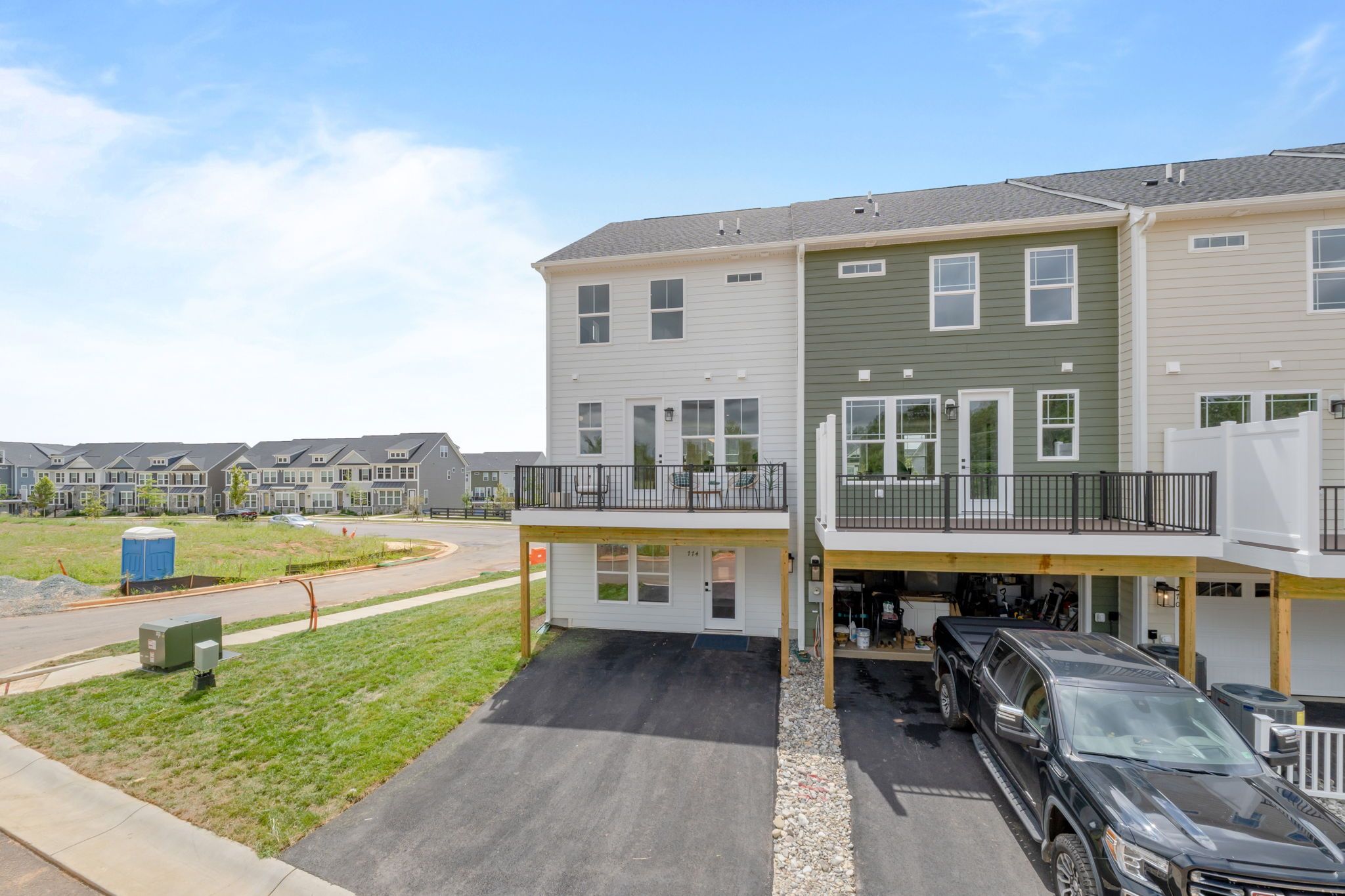 Rear of Home - Two Car Garage is standard; Sales office shown in photo