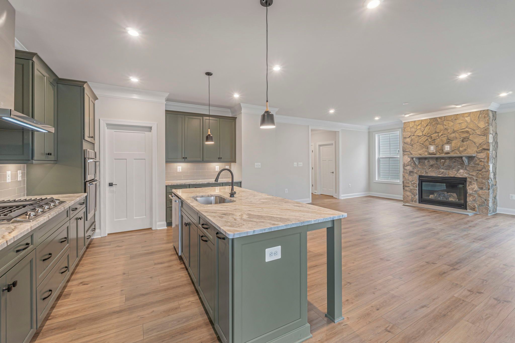 Kitchen, Dining Area and Family Room with Optional Stone Fireplace and Upgrades