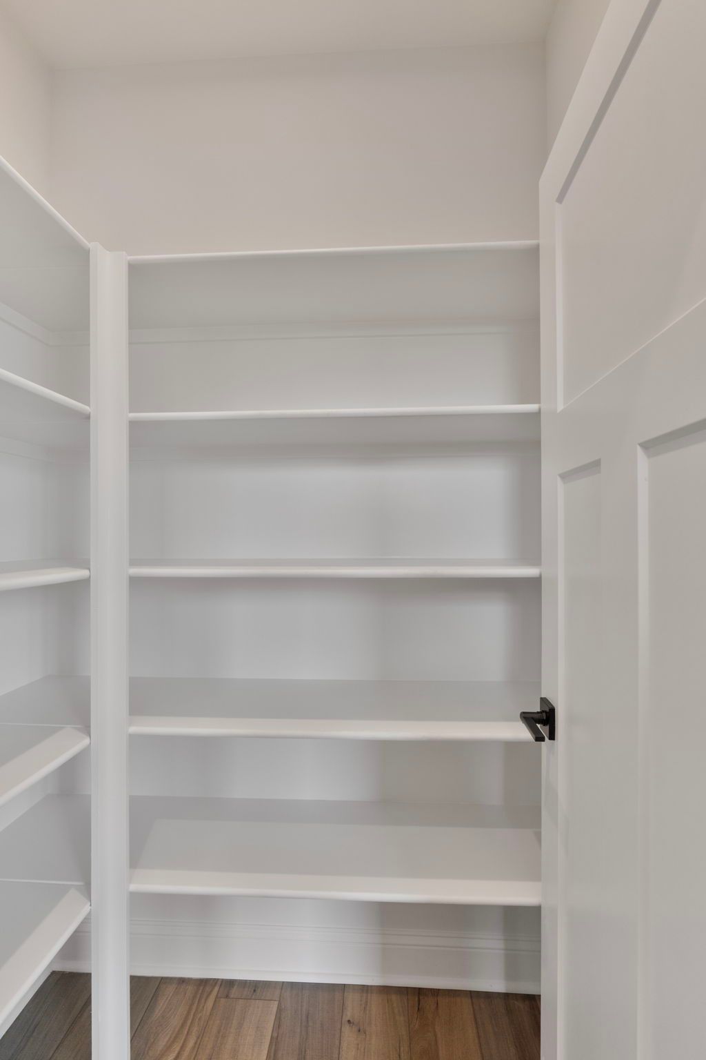 Main level pantry with wood shelving