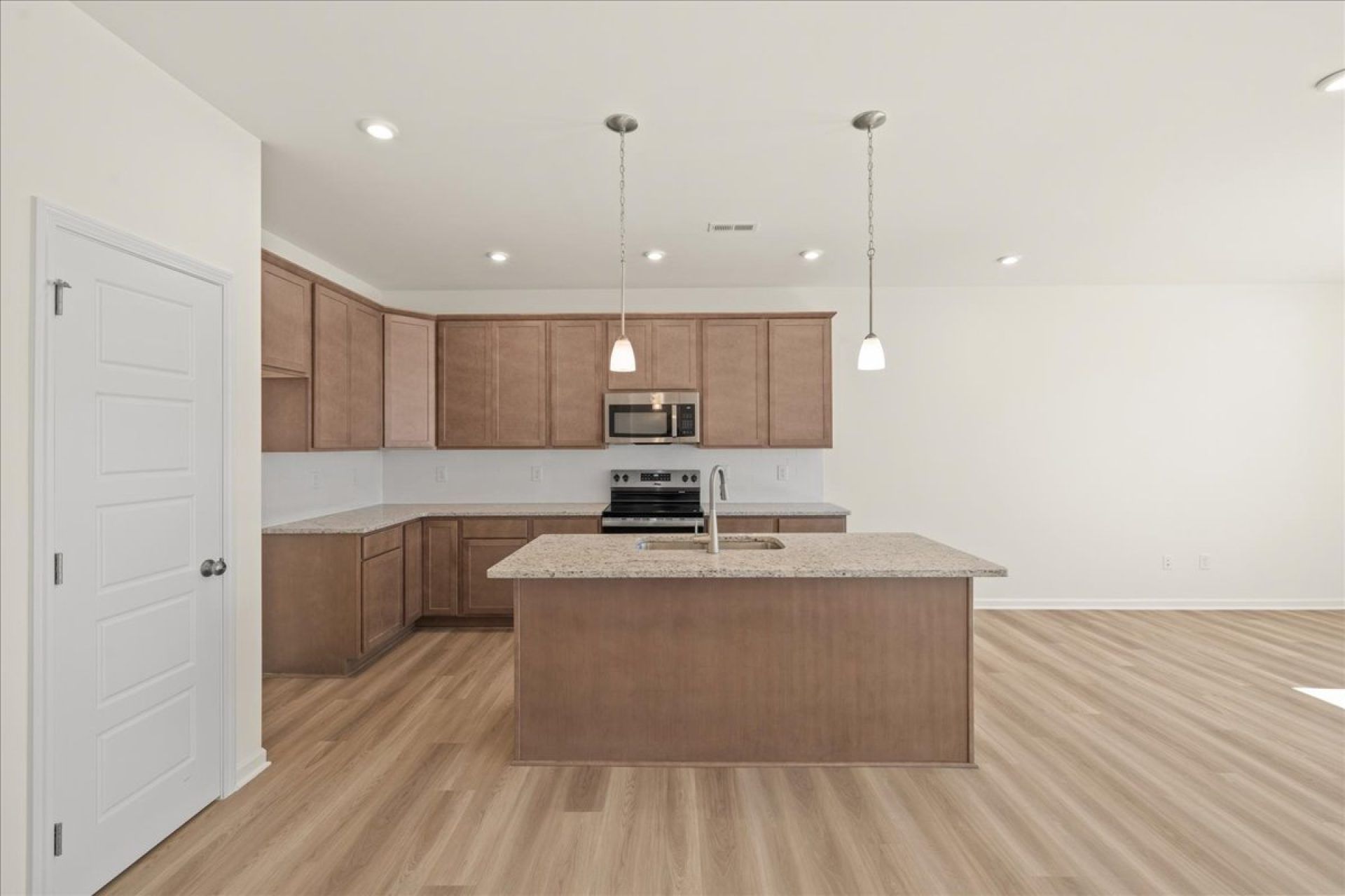 31-HHHunt Homes-Interior Layout-Lot 22-Whitfield-Kitchen Island View Brown Cabinets