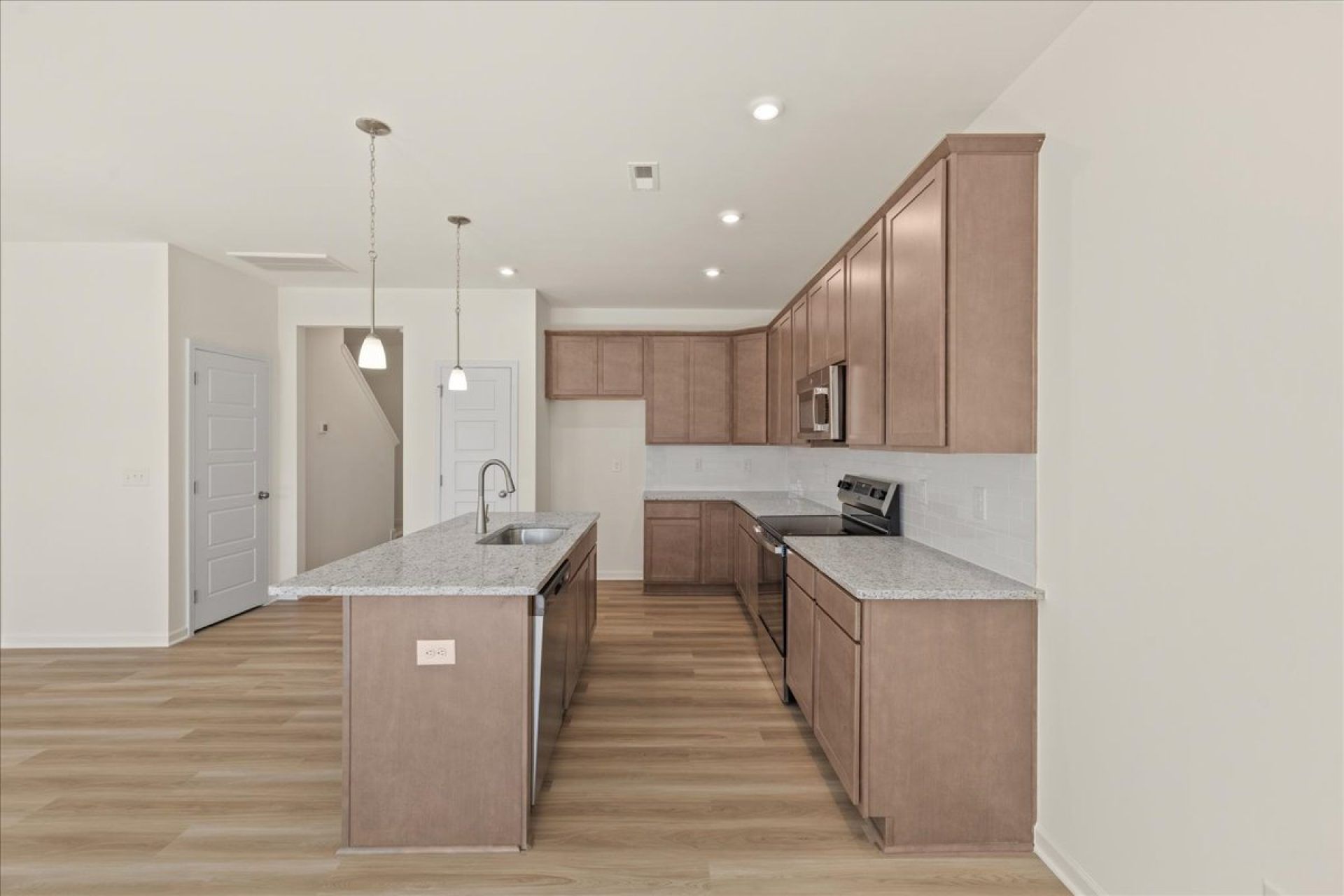 30-HHHunt Homes-Interior Layout-Lot 22-Kitchen Side View-Brown Cabinets-Whitfield