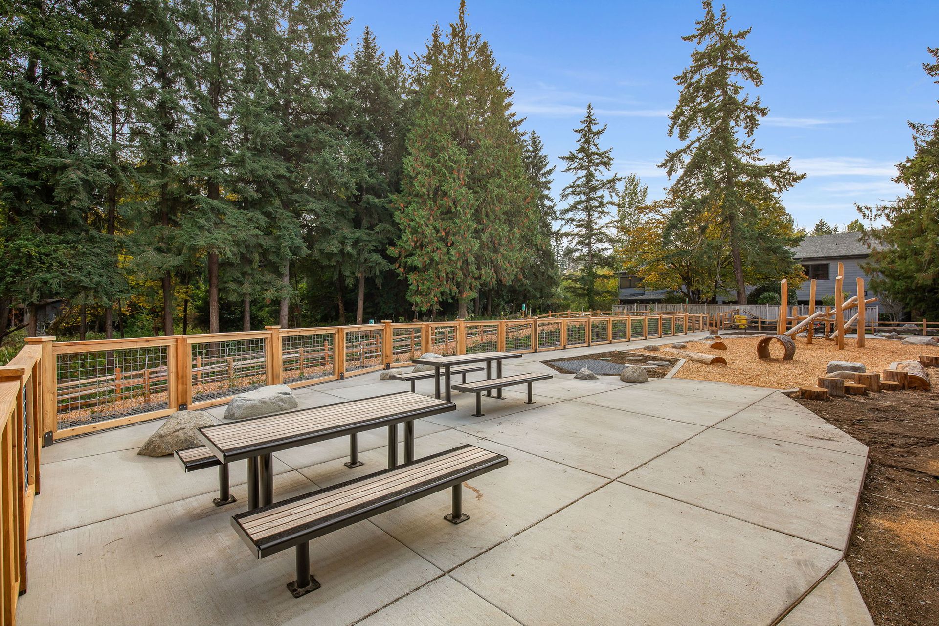Picnic tables and playground at the back of the community