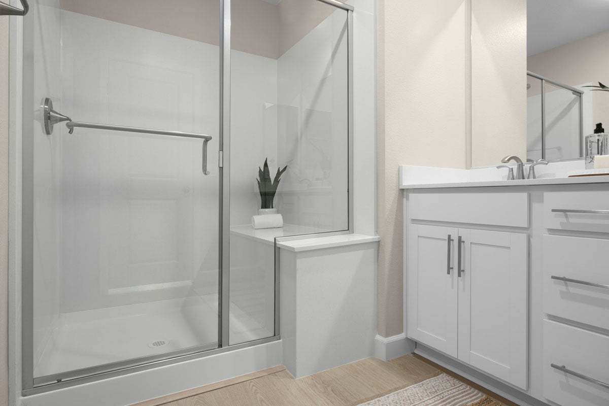Enlarged walk-in shower with seat at primary bath