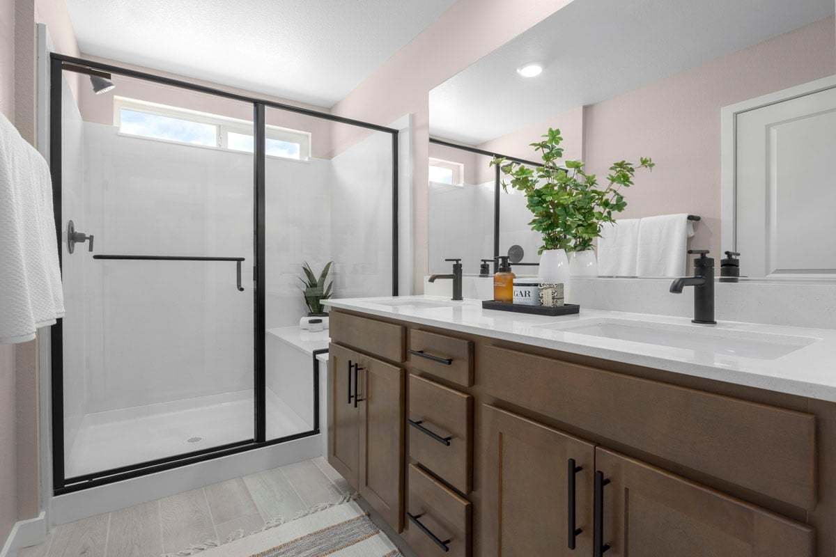 Enlarged walk-in shower with seat at primary bath
