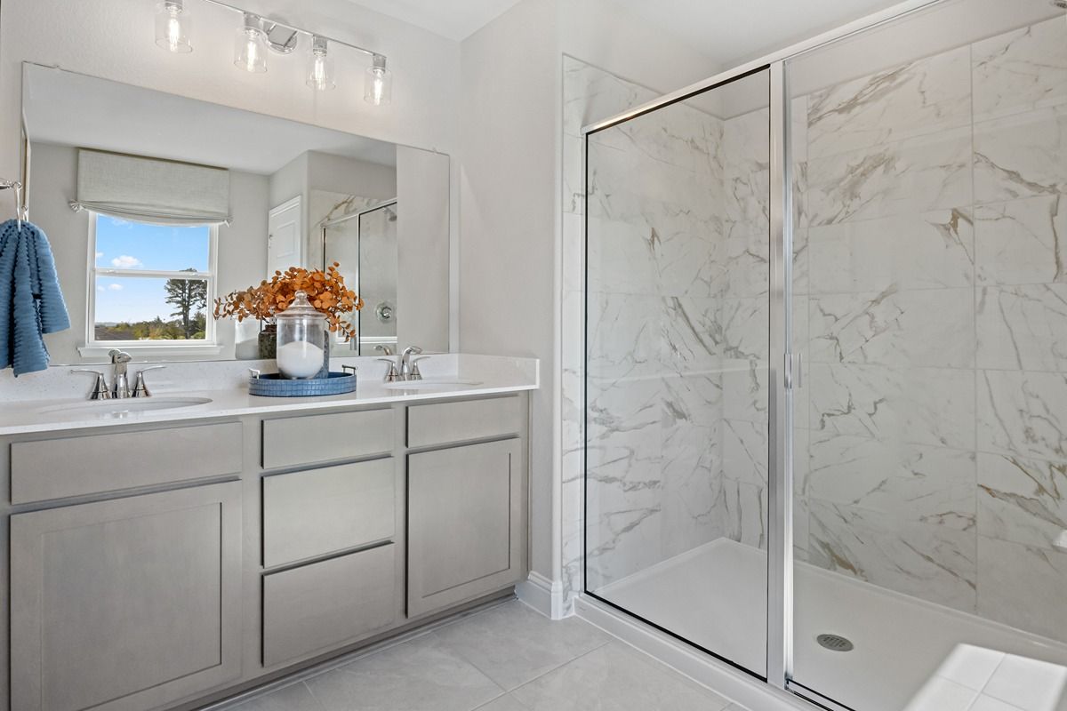 Plan 2444 Modeled - Walk-in shower with decorative tile surround at primary bath