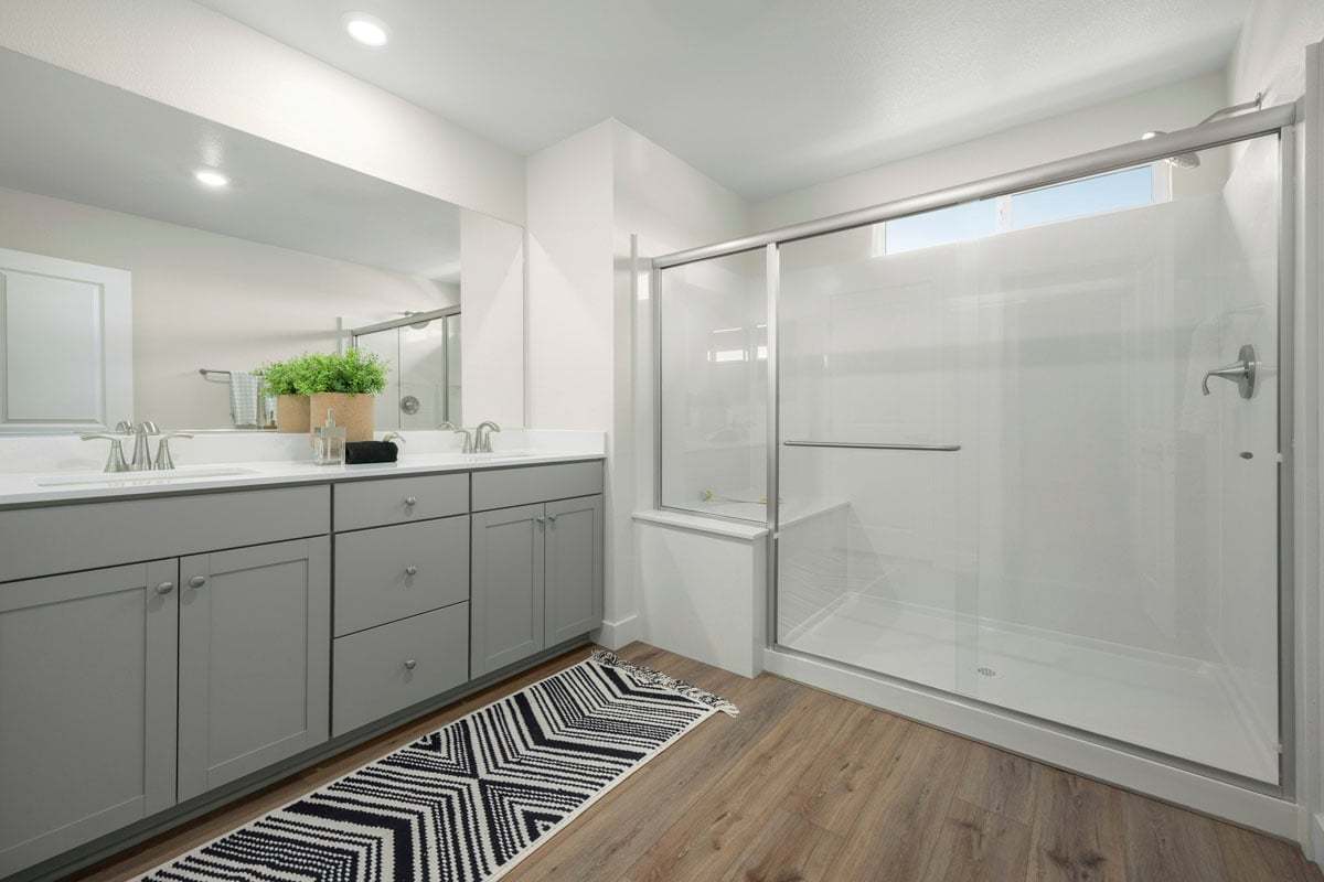 Enlarged walk-in shower with seat at primary bath