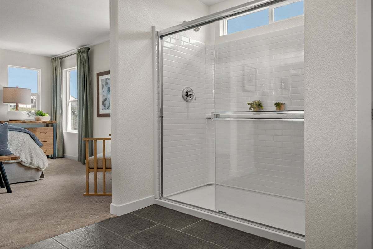 Plan 1652 Modeled - Walk-in shower with fiberglass surround and sliding doors at primary bath