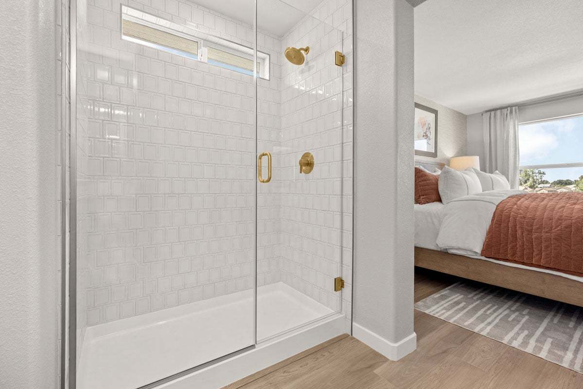 Plan 2102 Modeled - Walk-in shower with frameless clear glass enclosure at primary bath