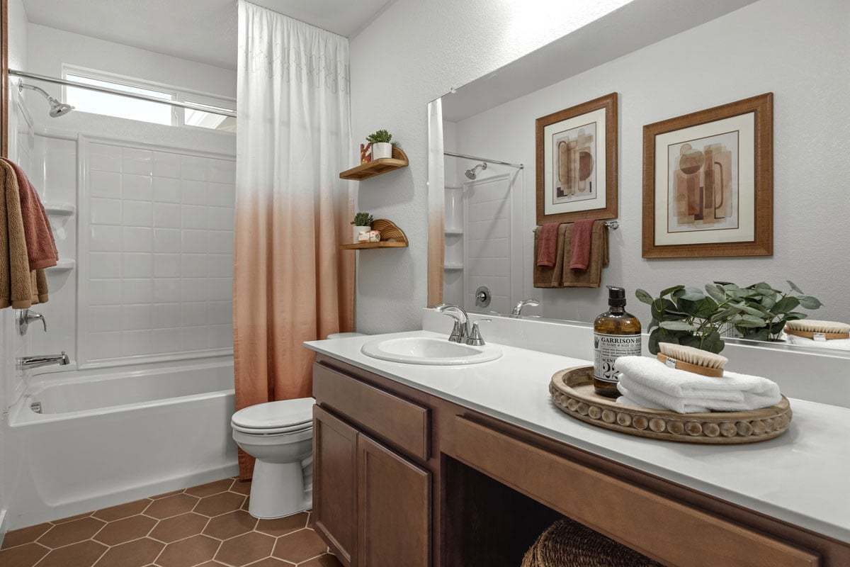 Plan 1507 Modeled - Extended vanity with solid-surface countertops and knee space at secondary bath