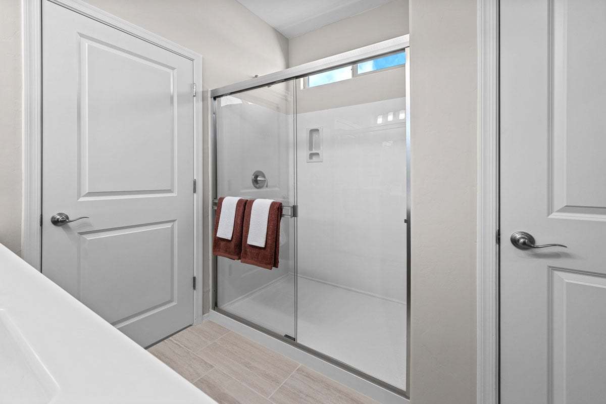 Plan 2013 Modeled - Walk-in shower with cultured marble surround at primary bath