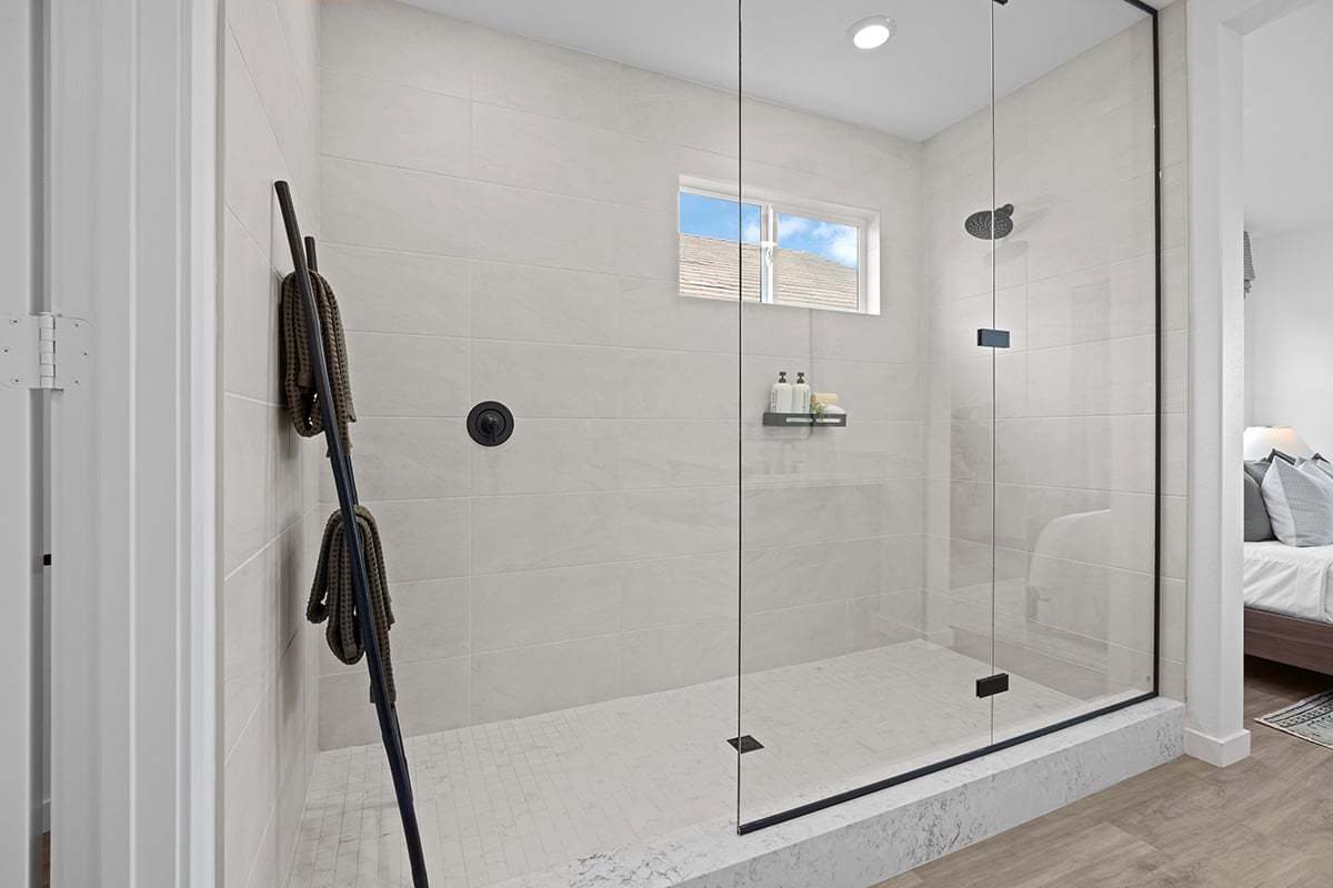 Plan 1878 Modeled - Extended walk-in shower with custom tile at primary bath