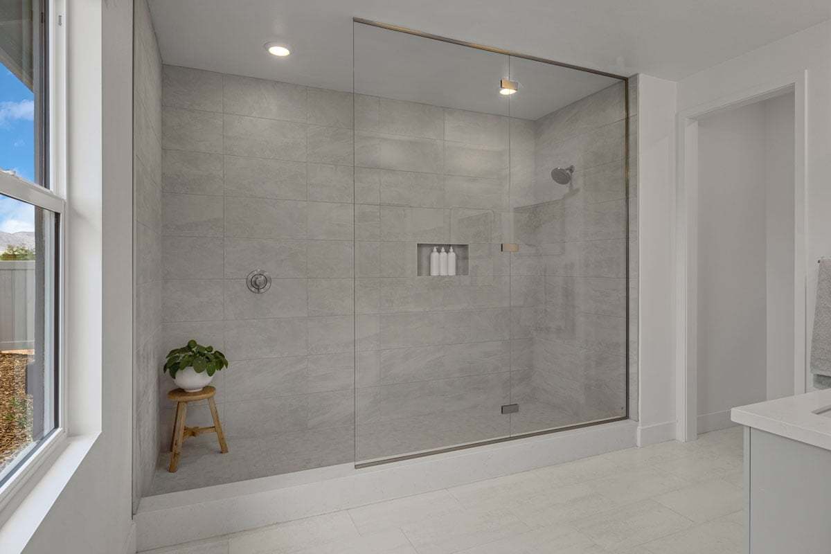 Plan 2758 Modeled - Extended walk-in shower with frameless glass enclosure at primary bath
