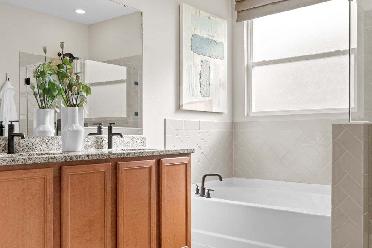 Garden tub with tile surround at primary bath