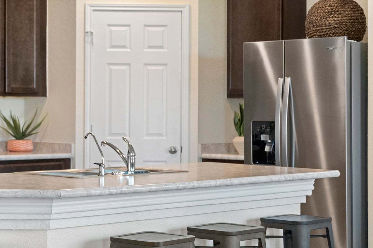 Plan 1548 Modeled - Stainless steel refrigerator at kitchen