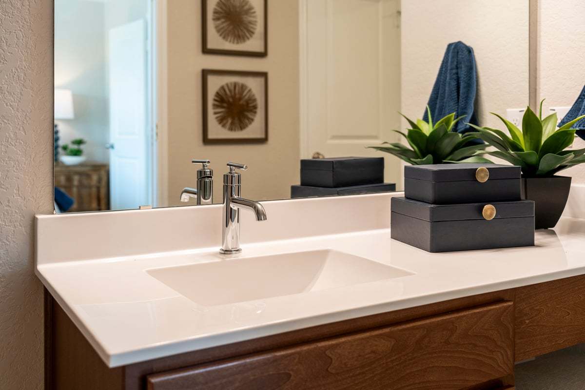 Plan 1676 Modeled - Cultured marble countertop with integrated sink at primary bath