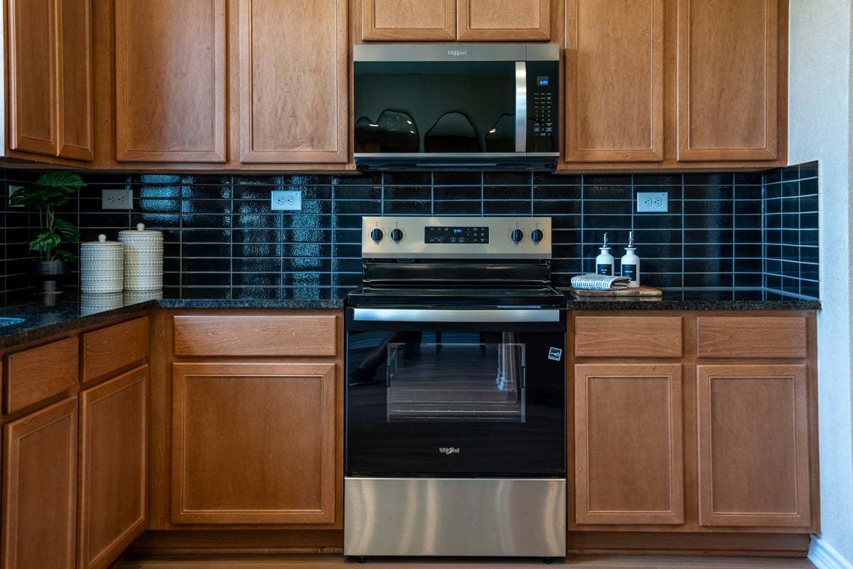 Plan 1676 Modeled -  Granite countertops with glossy stacked tile backsplash
