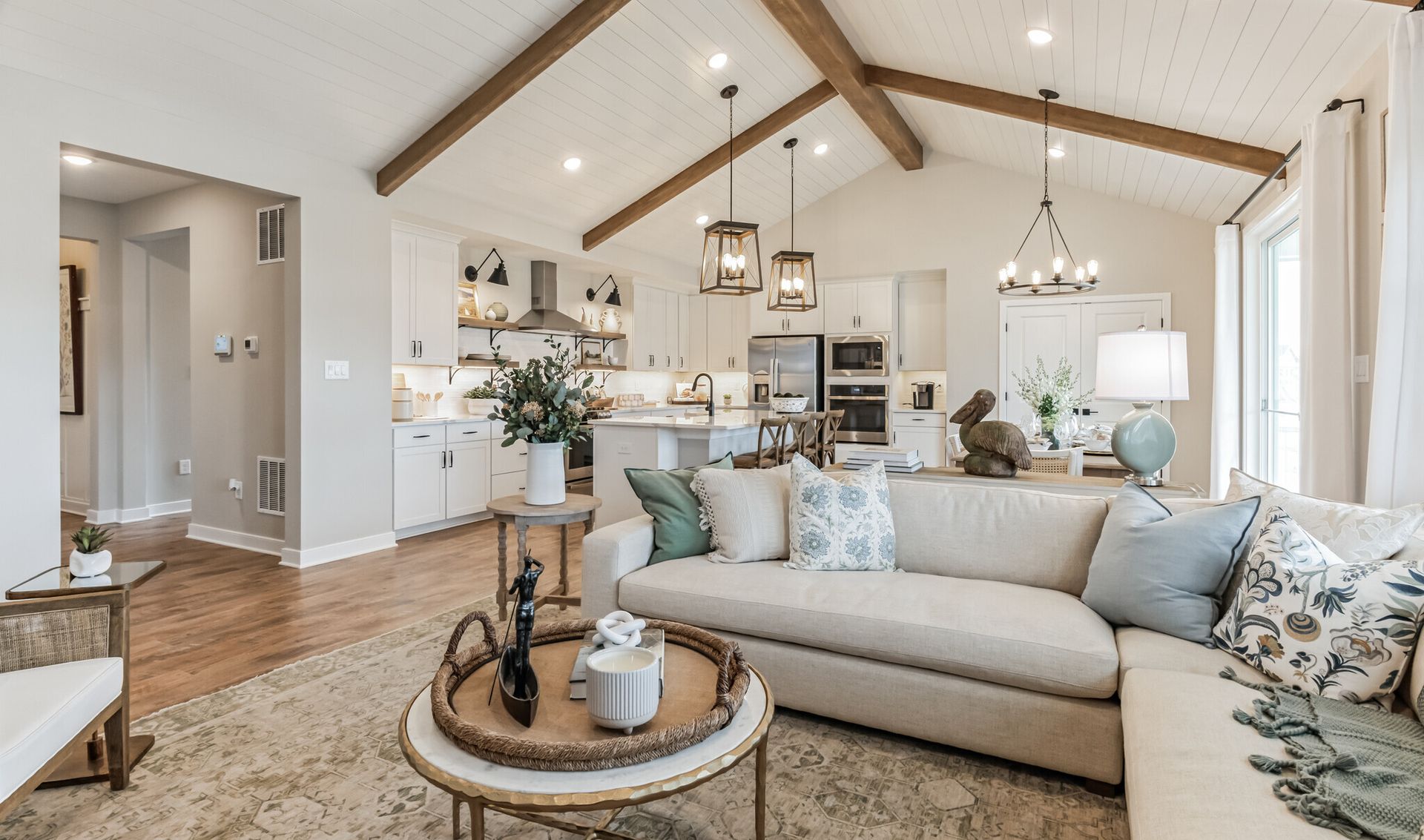 Great room with stained ceiling beams & vaulted ceilings
