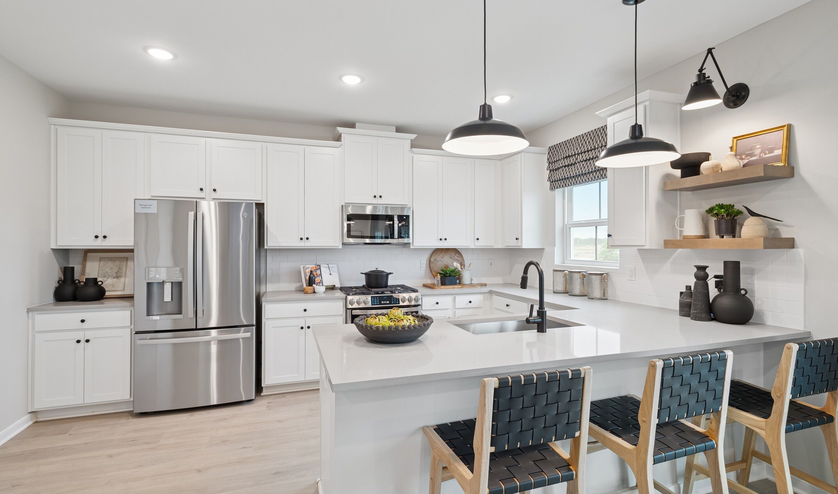 Kitchen with pendant lighting over peninsula island